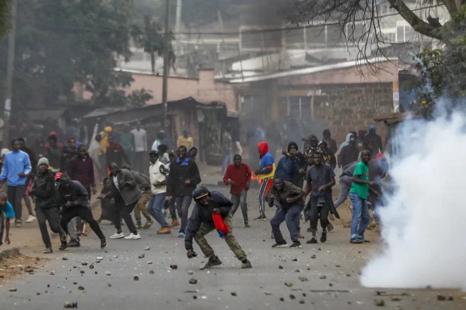Demonstrierende stehen neben einer Tränengaswolke und werfen während Zusammenstößen mit der Polizei Steine im Kibera-Viertel. In Nairobi wurde erneut gegen neu eingeführte Steuern und die hohen Lebenshaltungskosten demonstriert.